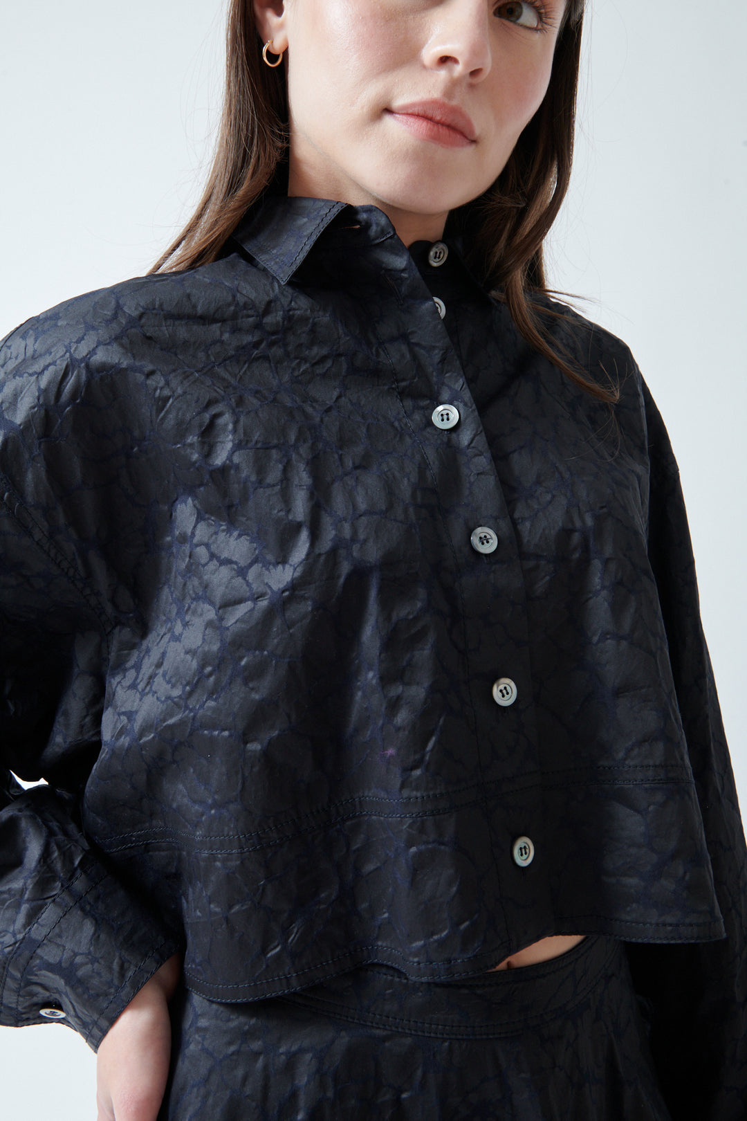 Angela wearing Mantu Janice Crop Blouse Chocolate Over Navy front/detail view