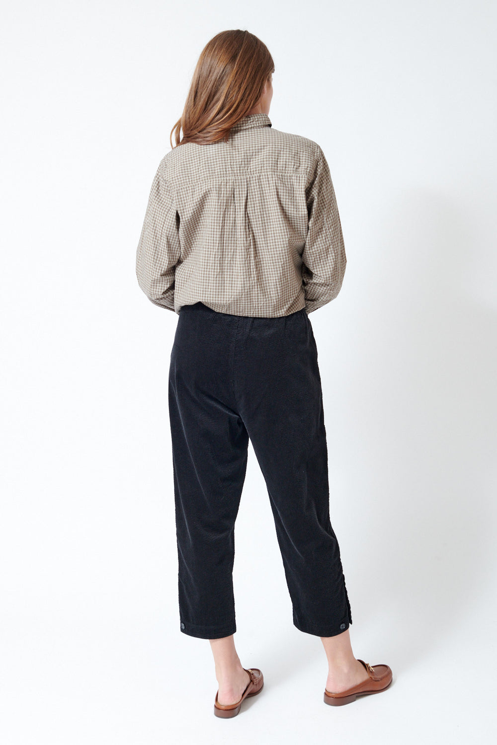 Julia wearing Pas de Calais Corduroy Tapered Pants in Black, rear view.