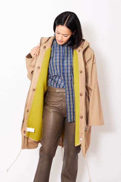 Front of Sofie D'Hoore Creed Hooded Parka With Detachable Lining Dune Mustard open to reveal detachable lining, worn by a model